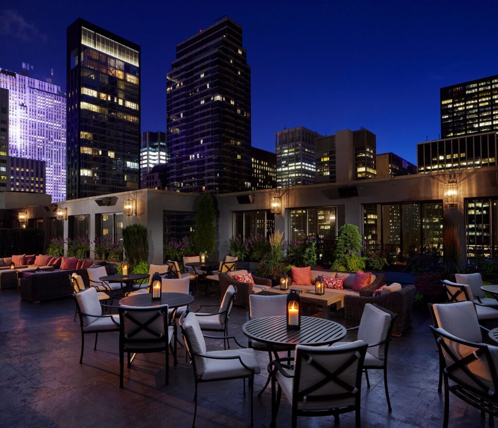 The Peninsula NYC terrace, evening skyline view.